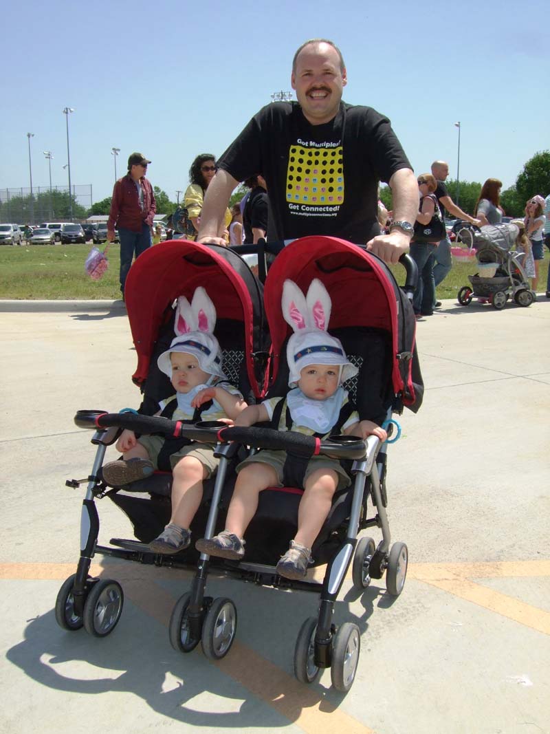 photo of parent pushing a stroller with twins